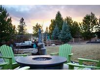 Inviting backyard with fire pit and outdoor seating area, perfect for relaxing evenings at 5893 Lasso Pl, Parker, CO 80134