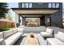 Relaxing outdoor patio with comfortable seating and views to the home's open kitchen and dining area at 1462 S Vine St, Denver, CO 80210