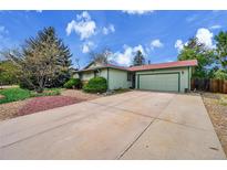 Charming single-Gathering home with a large driveway and colorful landscaping at 1669 S Uvalda St, Aurora, CO 80012