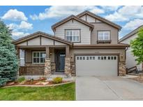 Charming two-story home featuring a covered porch and a well-maintained lawn, perfect for suburban living at 14258 Greenfield Loop, Parker, CO 80134