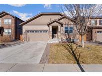 Charming single-Gathering home featuring a two-car garage and stone accents on a well-maintained lawn at 25127 E Maple Ave, Aurora, CO 80018