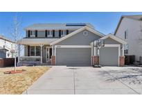 Inviting two-story home with a two-car garage, landscaped front yard, and a basketball hoop on the driveway at 4520 S Jebel Ct, Aurora, CO 80015