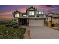 Inviting two-story home boasts a neutral color palette, a two-car garage, and a well-maintained front yard at 17464 Crestview Ct, Monument, CO 80132