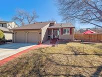 Charming single-story home with a two-car garage, landscaped yard, and inviting curb appeal at 7344 S Sheephorn Mtn, Littleton, CO 80127