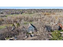 An aerial view of townhomes shows landscaping, parking, and green spaces at 9659 W Cornell Pl, Lakewood, CO 80227