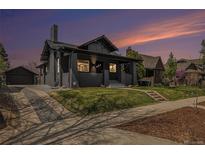 Charming single-Gathering home with a well-manicured lawn and an inviting covered front porch at 2659 Ash St, Denver, CO 80207