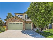 Charming two-story home with a stone facade and a three-car garage, perfect for a Gathering at 13962 Dexter Way, Thornton, CO 80602