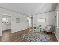 Cozy living room with modern décor and neutral color palette that gives the room an inviting feel at 957 Newton St, Denver, CO 80204