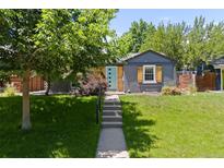 Charming home with a well-manicured front yard, steps to front door, and updated exterior finishes at 4451 Eliot St, Denver, CO 80211