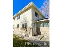 Charming townhouse featuring a well-maintained lawn and neutral-colored exterior paint at 7309 W Hampden Ave # 5202, Lakewood, CO 80227