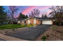 Charming stone exterior home with an attached two car garage and long asphalt driveway at 4788 Briar Ridge Trl, Boulder, CO 80301