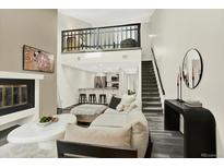 Inviting living room with modern decor, fireplace, and a loft area, creating a cozy and stylish atmosphere at 8055 E Colorado Ave # 8, Denver, CO 80231