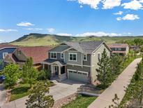 Two-story home with a well-manicured front yard and mountain views at 19782 W 59Th Ave, Golden, CO 80403