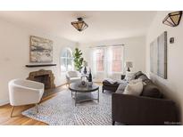 Inviting living room features a decorative fireplace, large windows, and stylish furniture for a comfortable living space at 1615 Locust St, Denver, CO 80220