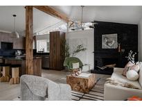 Bright living room featuring a fireplace, modern lighting, and unique architectural details at 1560 S Forest St, Denver, CO 80222