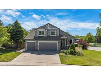 Charming two-story home with a well-manicured lawn and a two-car garage at 7696 S Hudson Way, Centennial, CO 80122