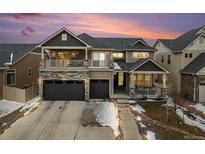 Beautiful two-story home with stone accents, a covered porch and two-car garage at 4981 Liverpool St, Denver, CO 80249