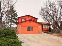 Charming two-story home featuring an attached two car garage and a spacious concrete driveway at 10010 Columbine Ct, Thornton, CO 80229