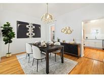 Beautiful dining room with modern chandelier, stylish decor, and hardwood floors at 1748 W 36Th Ave, Denver, CO 80211