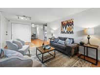 Cozy living room featuring comfortable seating, modern decor, and lots of natural light, perfect for relaxing or entertaining guests at 3047 W 47Th Ave # 112, Denver, CO 80211