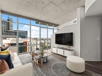Bright living room with floor-to-ceiling windows offering expansive city views and stylish modern decor at 891 14Th St # 2314, Denver, CO 80202