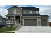 Charming two-story home featuring a welcoming front porch and a convenient two-car garage at 18103 House Finch Ln, Parker, CO 80134