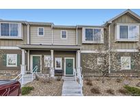 Charming townhouse featuring a well-maintained front exterior with a cozy entrance and landscaped surroundings at 14700 E 104Th Ave # 1404, Commerce City, CO 80022