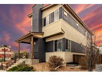 Contemporary two-story home with stylish siding, covered porch, and low-maintenance landscaping at 9791 Dunning Cir, Highlands Ranch, CO 80126