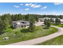 Spacious single Gathering home on acreage with mature trees, landscaping and generous parking at 30886 County Road 17/21, Elizabeth, CO 80107