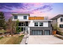 Modern two-story home featuring a two-car garage, landscaped front yard, and clean architectural lines at 942 S Fulton St, Aurora, CO 80247