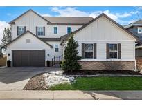 Charming two-story home with a two car garage and well-maintained lawn, perfect for suburban living at 2932 Newbury Ct, Highlands Ranch, CO 80126