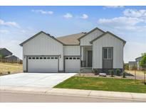 Charming home featuring a three-car garage, well-maintained lawn, and welcoming curb appeal at 13805 Emerald Lake St, Parker, CO 80138