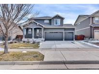 Charming two-story home featuring a three-car garage and stucco exterior at 5028 S Addison Way, Aurora, CO 80016