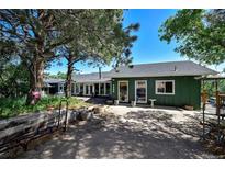 Charming single story exterior featuring a spacious parking area, lush trees, and beautiful landscaping at 4380 Sandstone Dr, Monument, CO 80132