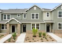 Charming townhome featuring neutral exteriors, landscaping, and inviting entrances at 17115 W 91St Ln, Arvada, CO 80007