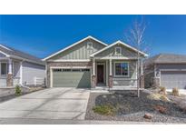 Charming home featuring a two-car garage, covered porch, and low maintenance landscaping at 2153 Abigail Ln, Castle Rock, CO 80104