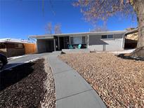 Ranch style home with landscaped yard and walkway at 187 Yates St, Denver, CO 80219