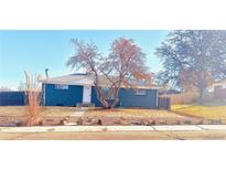 Charming blue single-story home featuring a well-manicured front yard and inviting curb appeal at 10526 Humboldt St, Northglenn, CO 80233