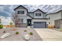 Beautiful two-story home featuring stone accents, gray siding, a two-car garage and a manicured front yard at 2197 S Jackson Gap St, Aurora, CO 80018