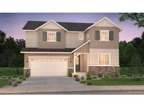 Charming two-story home featuring stone accents, a two-car garage, and manicured landscaping at 2197 S Jackson Gap St, Aurora, CO 80018