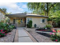 Charming brick home featuring a well-maintained front yard with lovely landscaping and walkway at 1275 Fairfax St, Denver, CO 80220