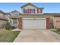 Charming two-story home featuring a large garage and red shutters at 12362 Nate Cir, Parker, CO 80134