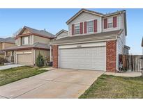 Charming two-story home featuring a large garage and red shutters at 12362 Nate Cir, Parker, CO 80134