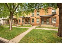 Charming brick townhomes featuring neat front lawns and inviting entrances at 709 27Th St, Denver, CO 80205