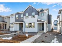 Charming two-story home featuring two-tone gray paint, well-manicured front yard, and inviting entrance at 1419 Great Western Dr, Longmont, CO 80501