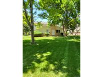 Charming home with a well-maintained lawn, mature trees and a welcoming front entrance at 9105 E Lehigh Ave # 105, Denver, CO 80237