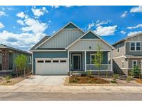 Charming blue two-story home featuring an attached garage and welcoming front porch at 8245 Cokedale Cir, Littleton, CO 80125