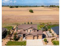 Expansive aerial view of a beautiful house with a three-car garage and scenic views at 953 Compass Dr, Erie, CO 80516