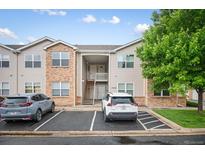 Inviting multi-story townhome with brick and siding, plus reserved parking spaces at 11640 W 62Nd Pl # 203, Arvada, CO 80004