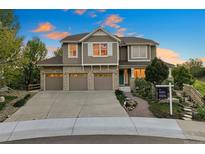 Beautiful two-story home with a three-car garage and well-manicured landscaping at 4704 Cedar Glen Pl, Castle Rock, CO 80109